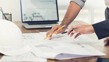 Architects Discussing A Design-build Project In The Office