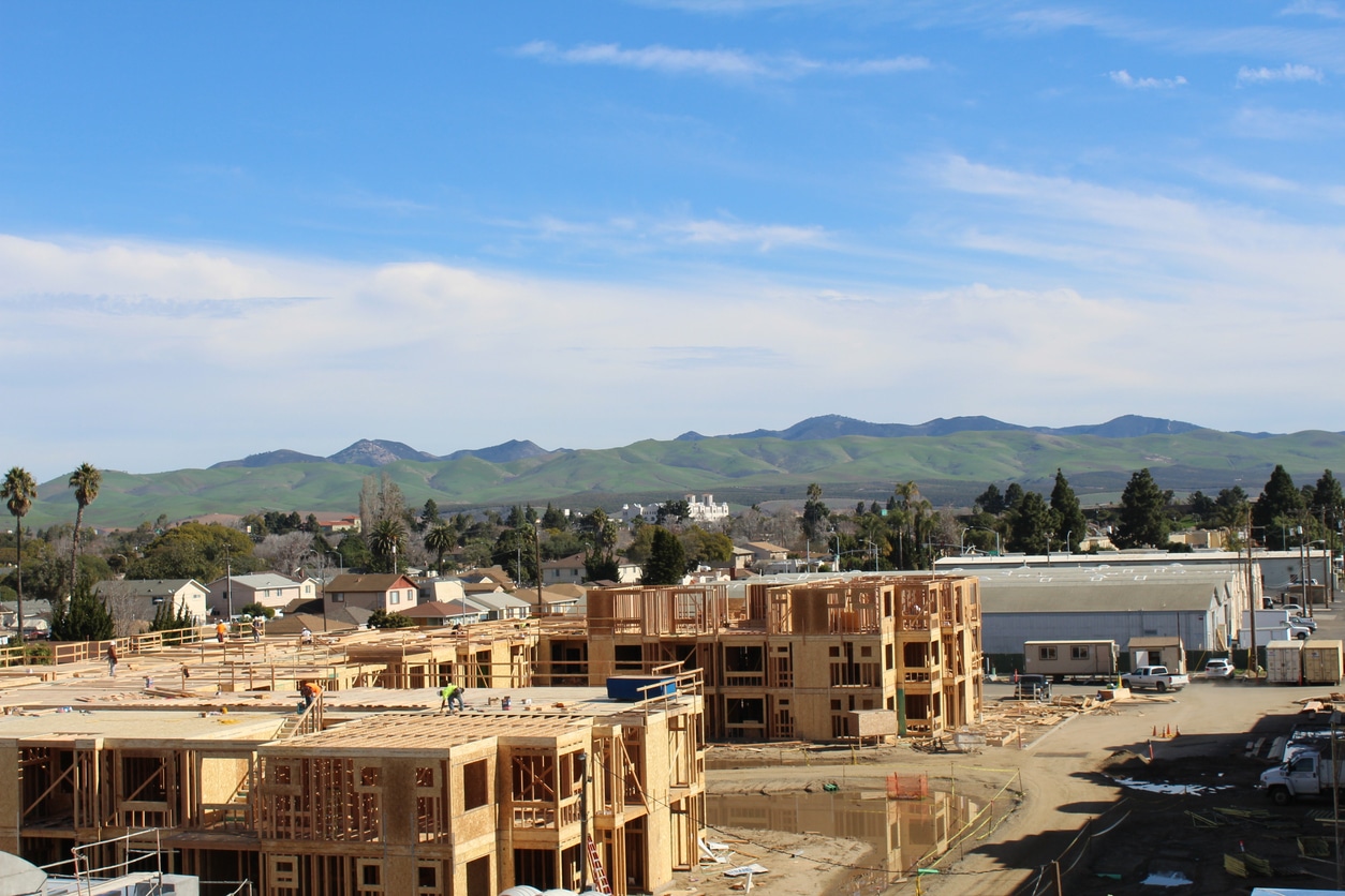 An aerial image of a construction site for a large, multi-unit commercial space.