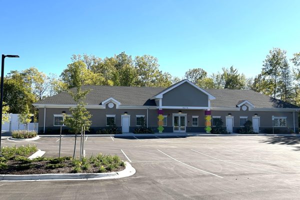 Completed childcare facility exterior showcasing modern construction, clean architectural design, and ample parking, reflecting a finished commercial development ready for operation.
