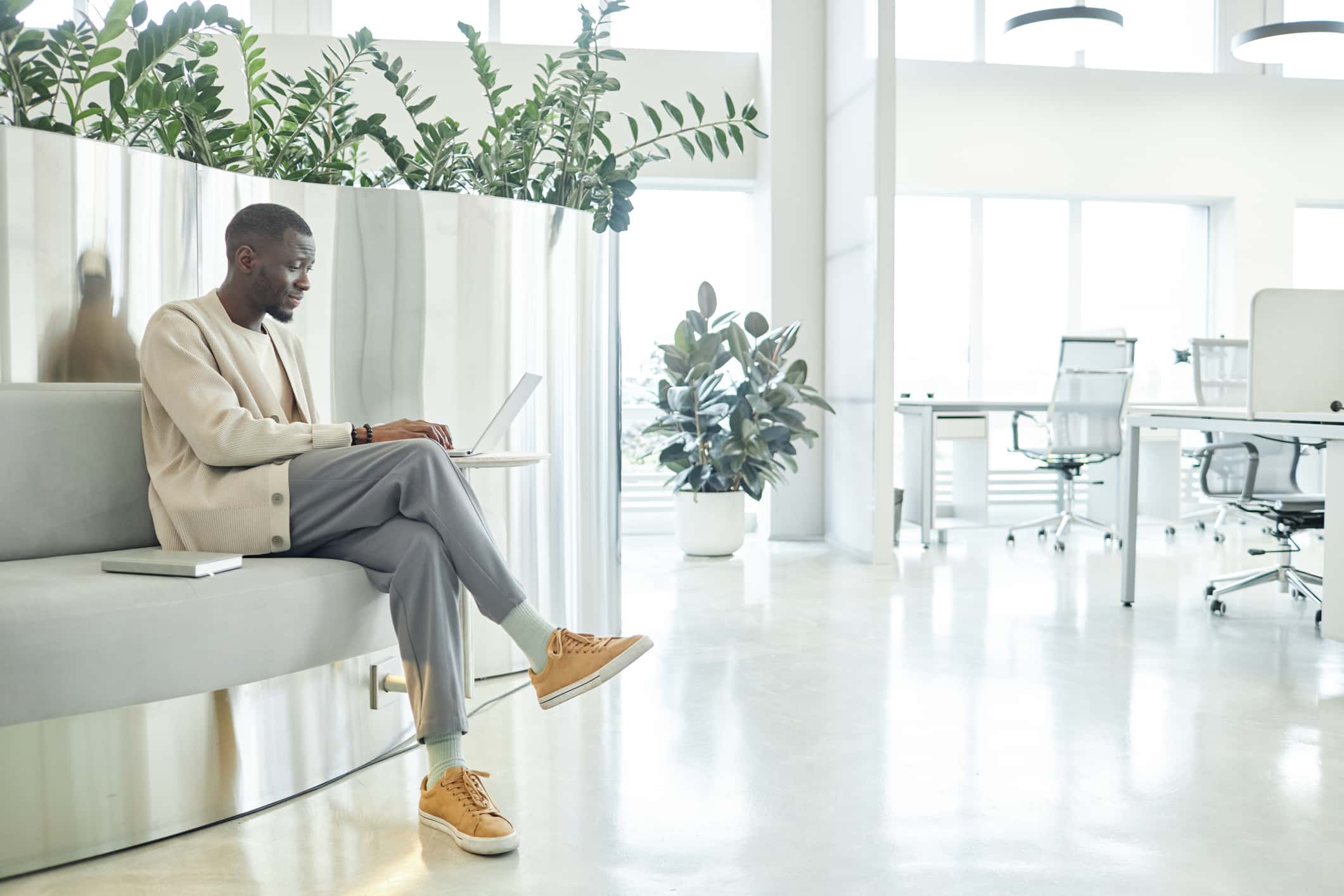 An open, modern, collaborative workspace, flooded with natural light.
