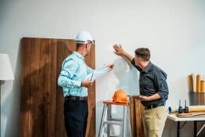 A business owner goes over commercial construction risks with a commercial contractor. 