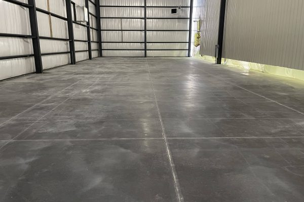 Interior of a pre-engineered metal building with a poured concrete floor and steel framing, built by Schonsheck in Michigan