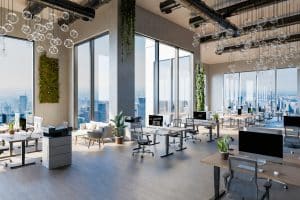 Large innovative open space office with tech industry workplaces and greenery