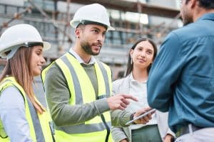 Commercial contractor reviewing building plans at an active construction site.